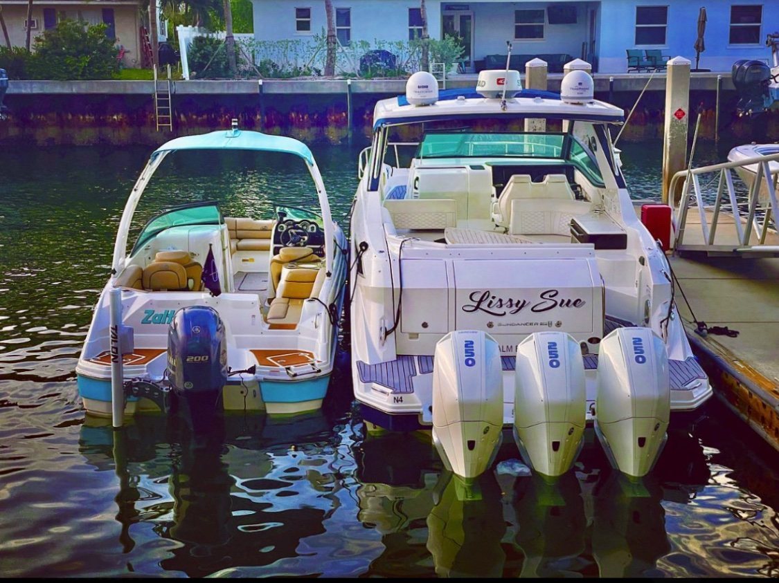 Two boats tied up at the dock, including the Sundancer Lissy Sue