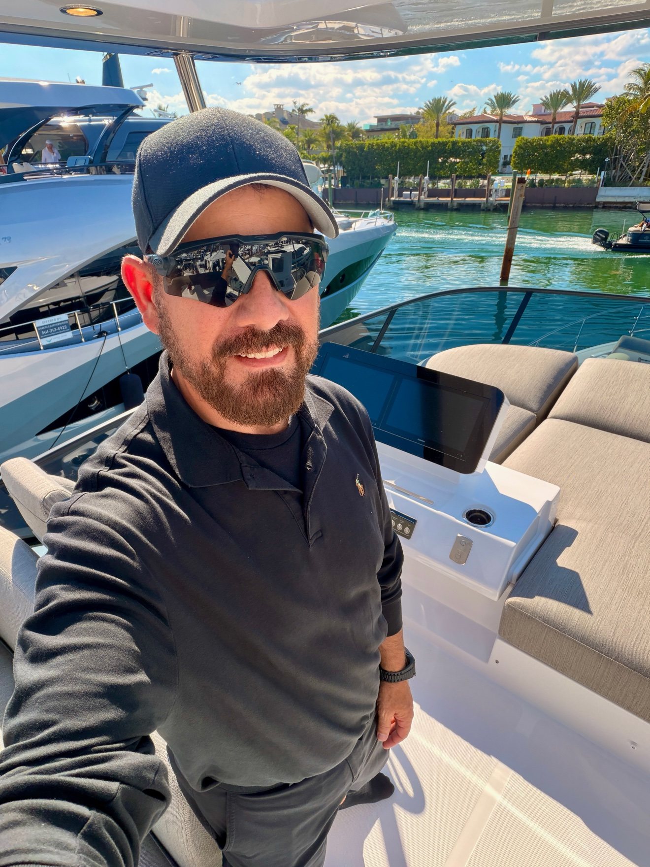 Capt. José Martín on the flybridge with Palm Beach waterfront homes behind