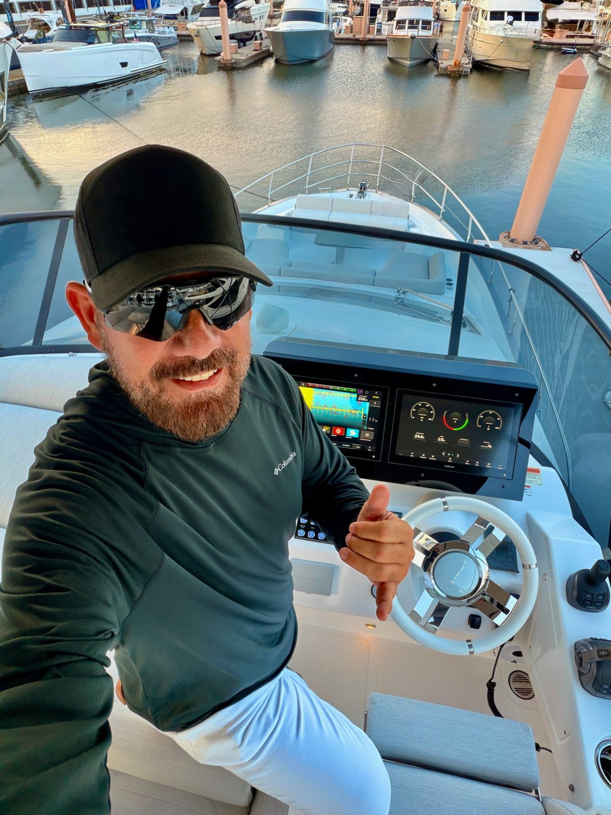 Capt. José Martín at the helm of his Azimut at golden hour