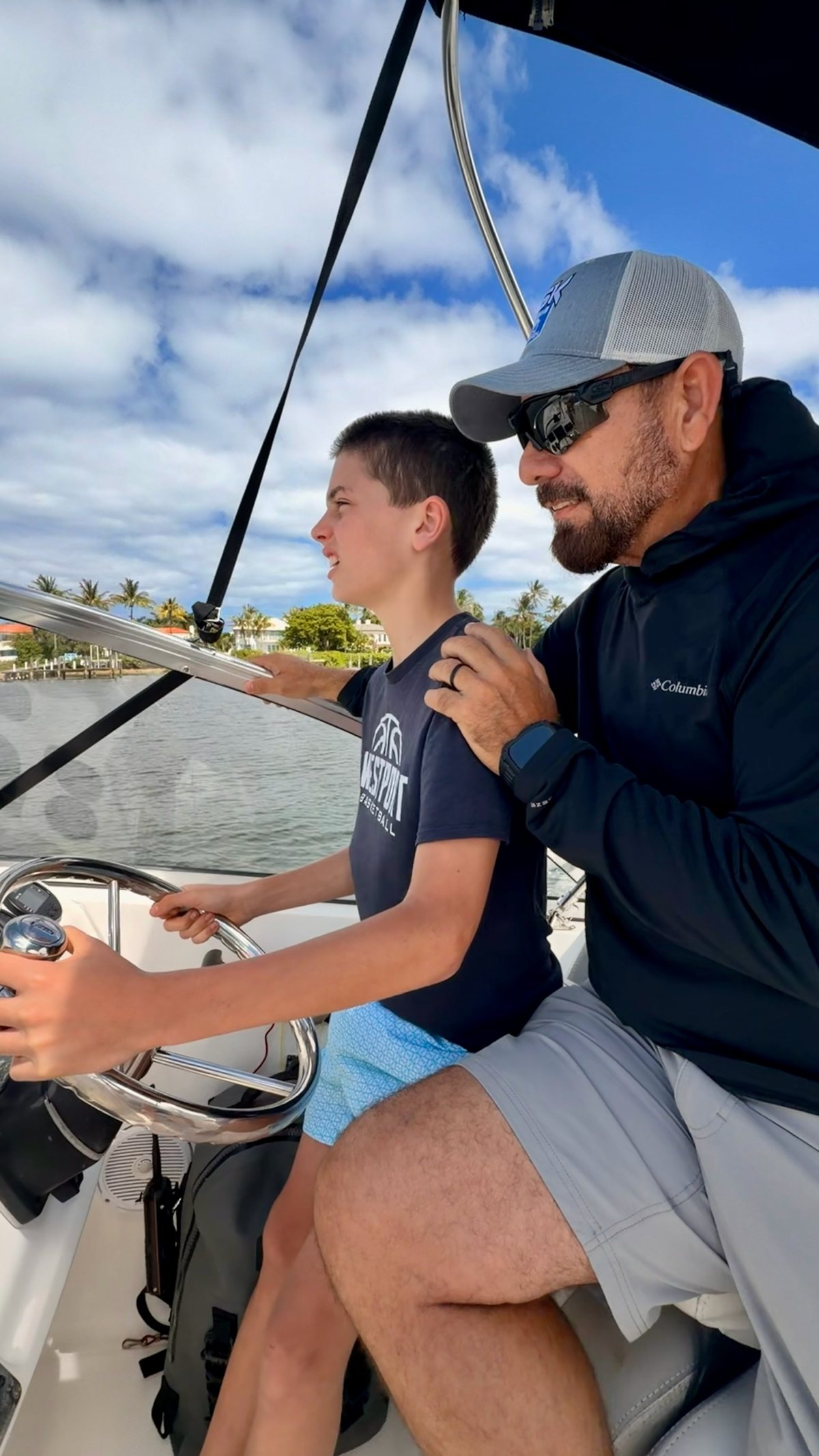 Capt. José Martín teaching a young guest at the helm